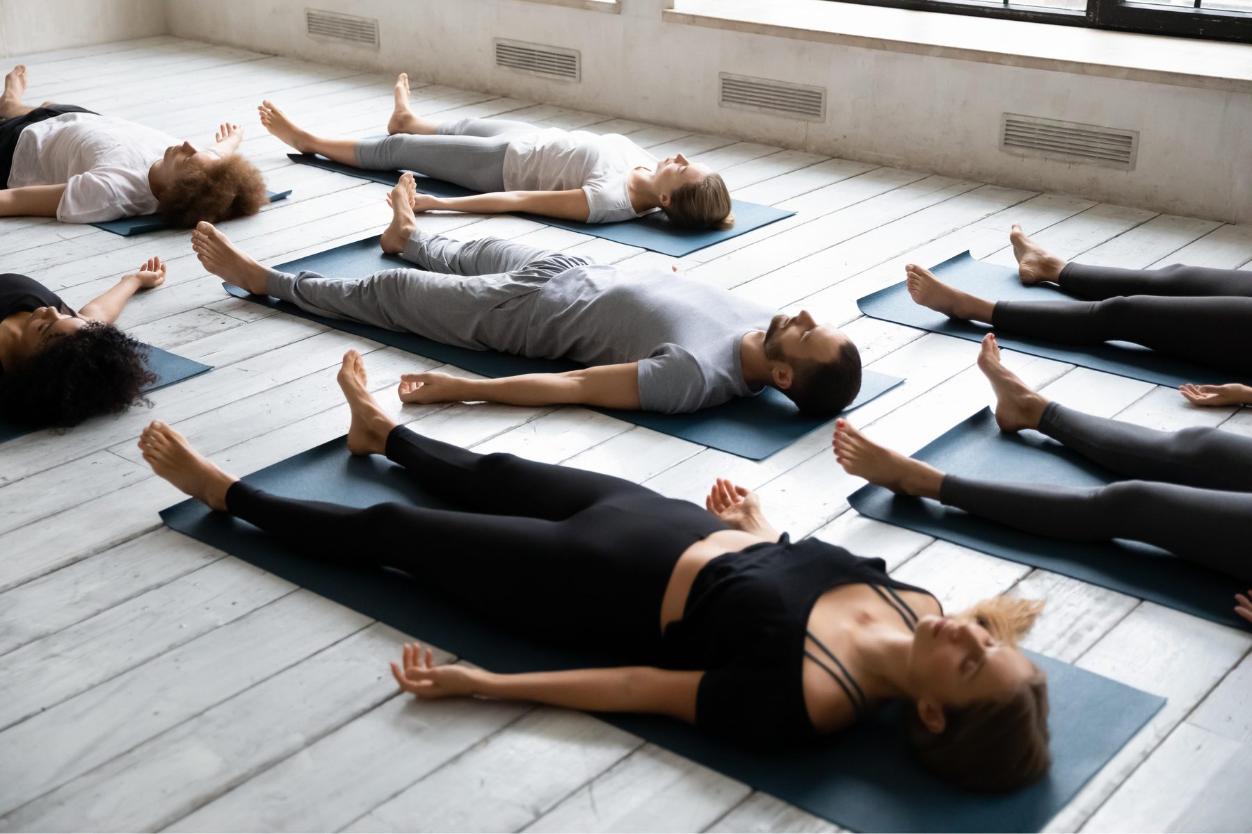 A small group sitting in a circle before a breathwork class